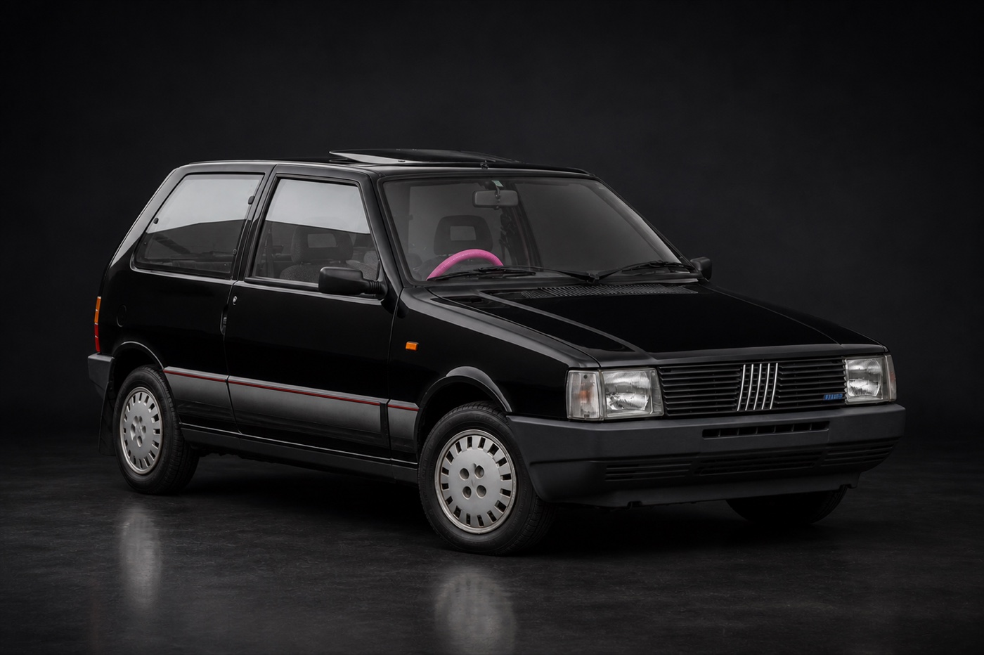 Black; neon-pink steering wheel Fiat Uno (Sarah) in a dark photographic studio