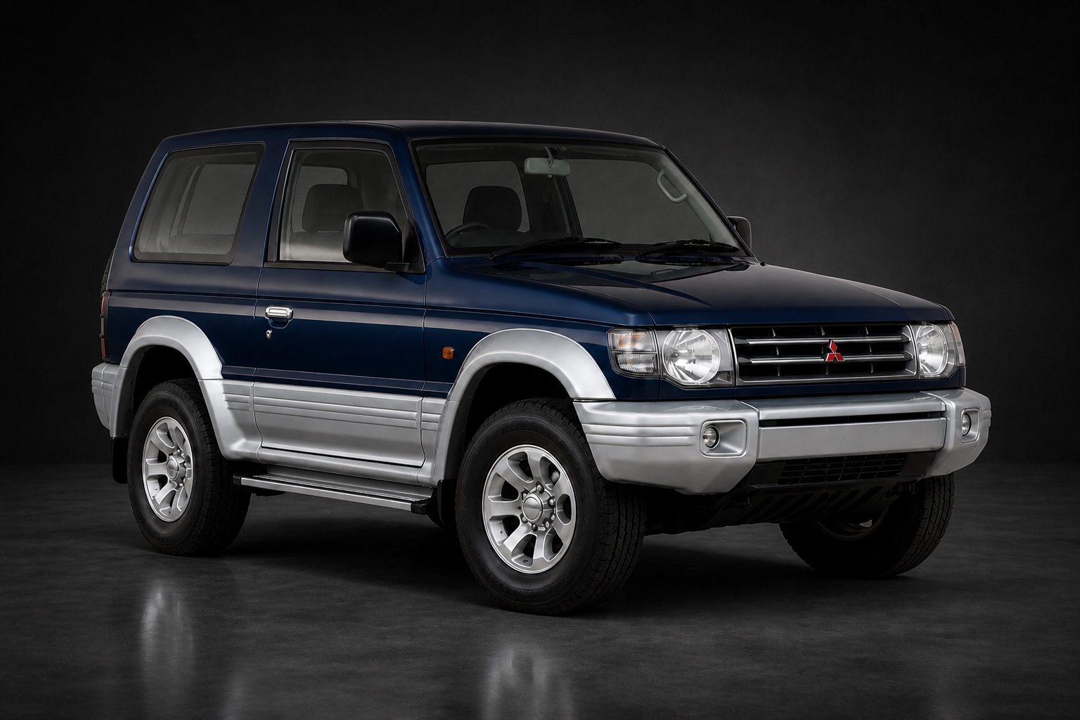 Dark Blue & Silver Mitsubishi Shogun “Skygun” (3-door SWB) in a dark photographic studio