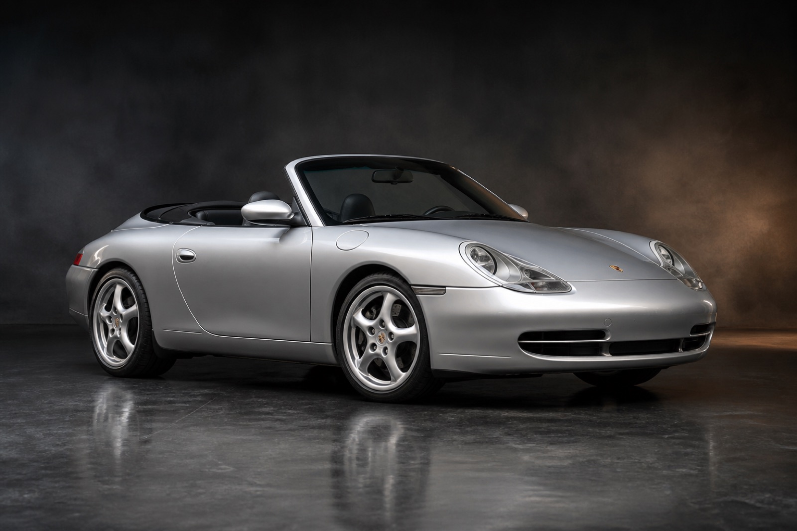 Silver (Arctic Silver) Porsche 911 Carrera Cabriolet (996) in a dark photographic studio