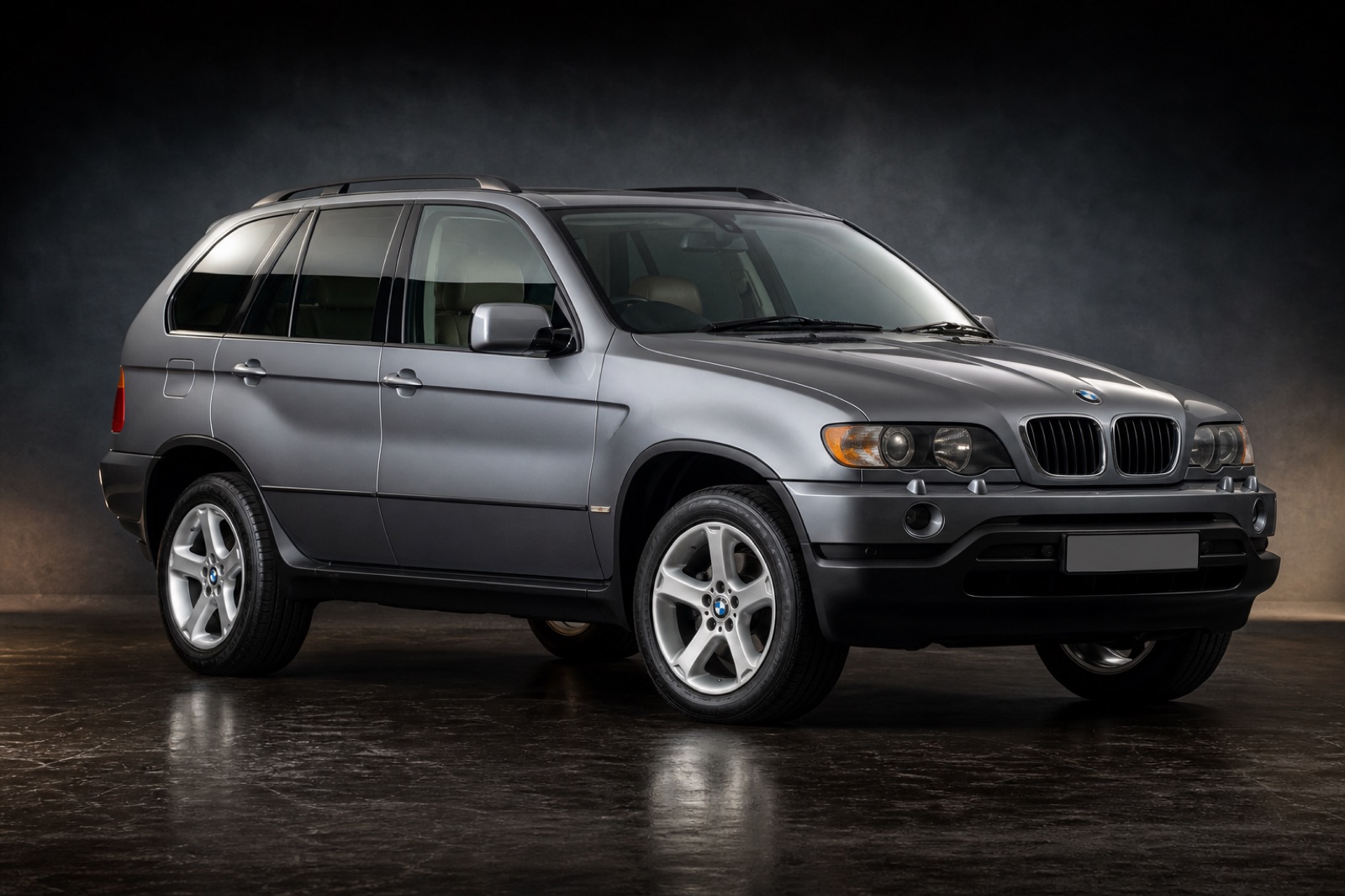 Grey BMW X5 3.0d (E53, 1st gen) in a dark photographic studio