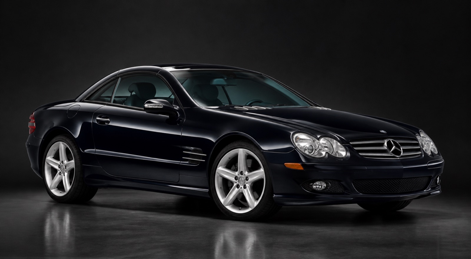 Dark Blue/Black Mercedes SL500 in a dark photographic studio