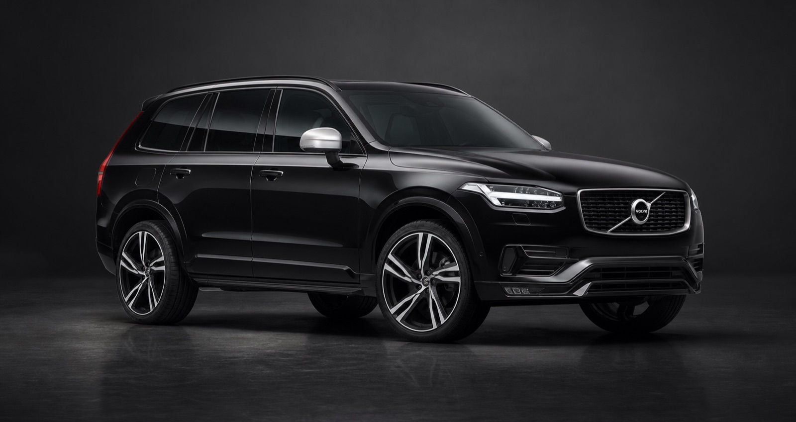 Metallic Onyx Black, Charcoal leather Volvo XC90 T8 Hybrid R-Design Pro in a dark photographic studio